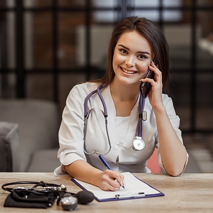 beautiful-young-female-medical-private-doctor-is-looking-camera-smiling Female Doctor at a medical office using the best medical answering service to manage calls