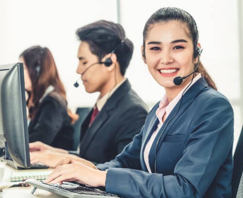 Virtual Receptionists wearing headsets working in the office to support Seasonal Businesses