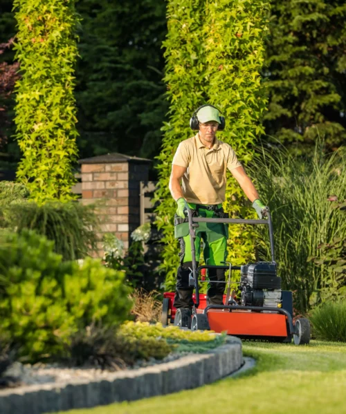 garden-lawn-care-maintenance landscaping answering service: landscaper working in garden for lawn care maintenance wi