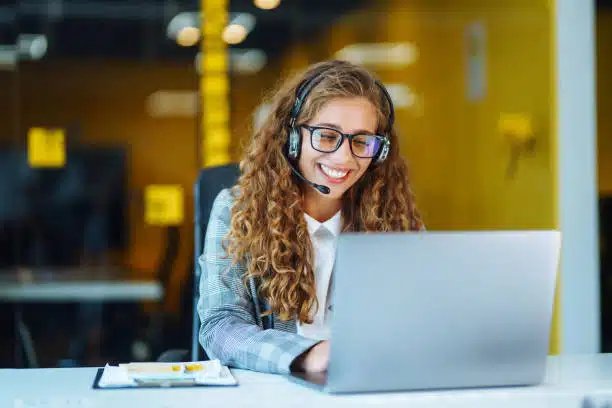 Virtual Receptionist with headset working on support hotline phone call in office