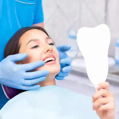 Dentist examines young patient with support from best answering service for dental office
