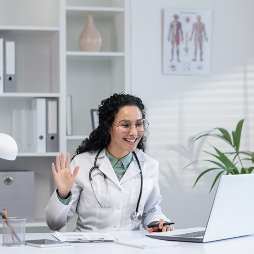 friendly-hispanic-female-doctor-white-coat-waving-video-call-consultation-bright Medical professional receiving calls with a medical healthcare virtual receptionists