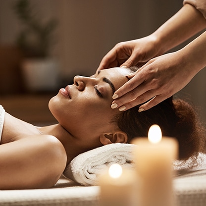 attractive-african-woman-enjoying-face-massage-spa-salon Holistic healer using a holistic healing answering service to manage patient calls