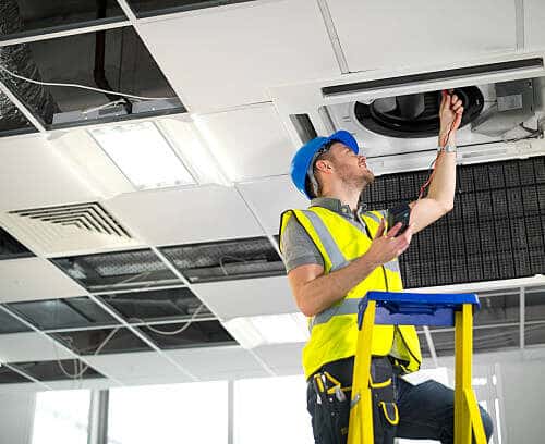 HVAC contractor fitting air conditioning to office interior_alt