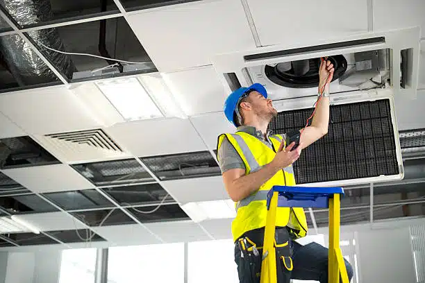 HVAC contractor fitting air conditioning to office interior_alt
