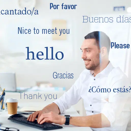 Smiling man at a desk with multilingual greetings on screen, symbolizing a bilingual virtual receptionist service.
