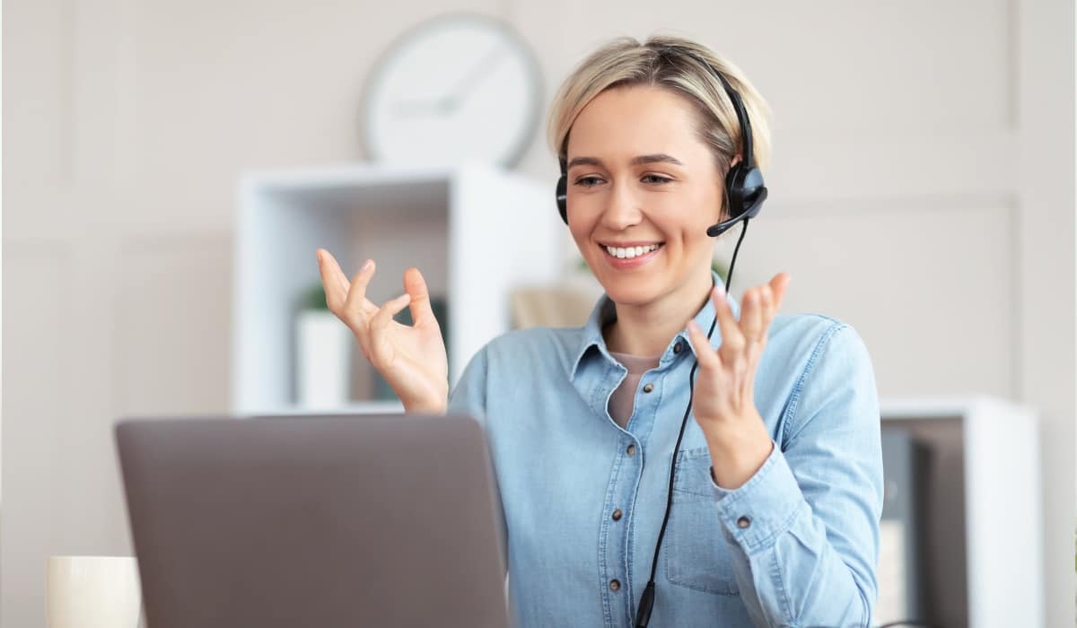 Bilingual Virtual Receptionist Assisting Clients Bilingual virtual receptionist wearing a headset during a video call, assisting clients remotely.