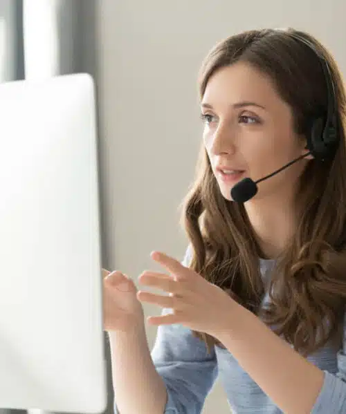 Woman with headset providing bilingual virtual answering service for a law firm during a call at her desk