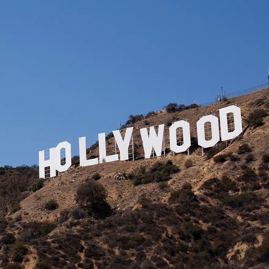 Hollywood sign on a hill against a clear blue sky in Los Angeles, California.
