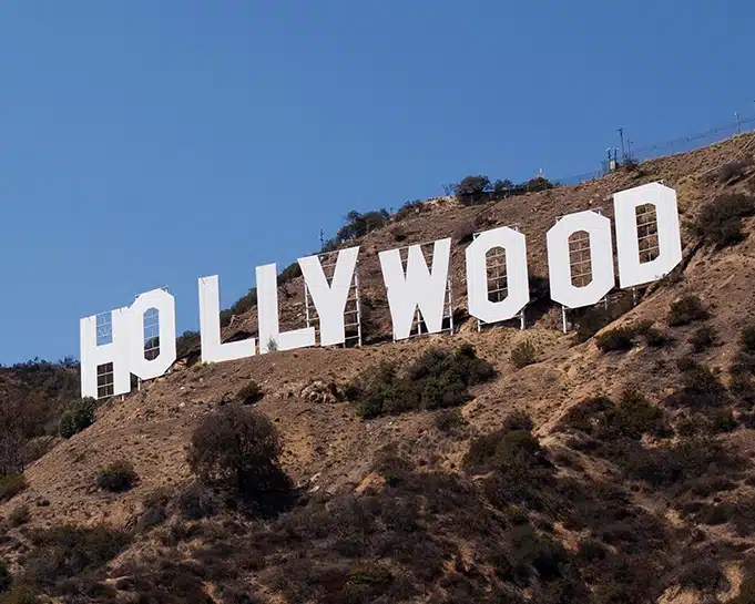 Hollywood sign on a hill against a clear blue sky in Los Angeles, California.
