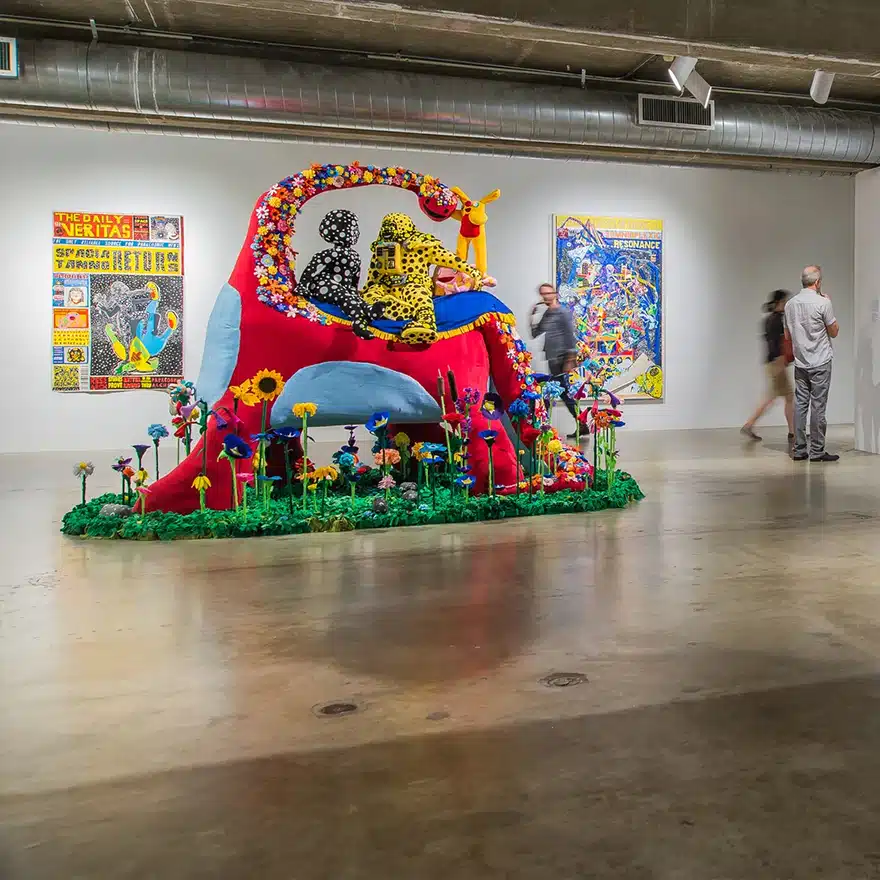Colorful art installation at an art gallery with people admiring the artwork in Houston.