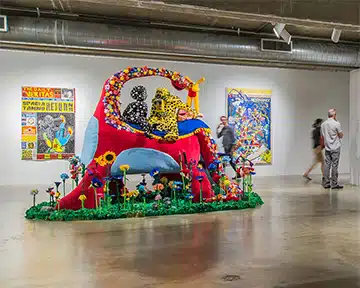 Colorful art installation at an art gallery with people admiring the artwork in Houston.