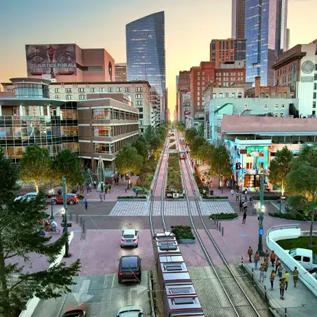 Downtown Houston with modern architecture and a light rail in view during sunset.
