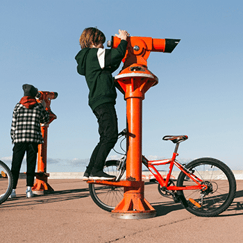 People using binoculars at a scenic location in California