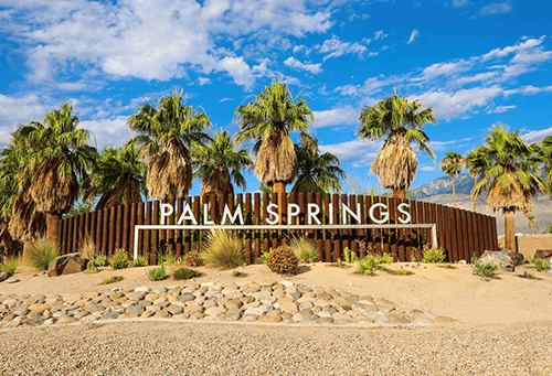 Palm Springs entrance sign surrounded by desert landscape in California
