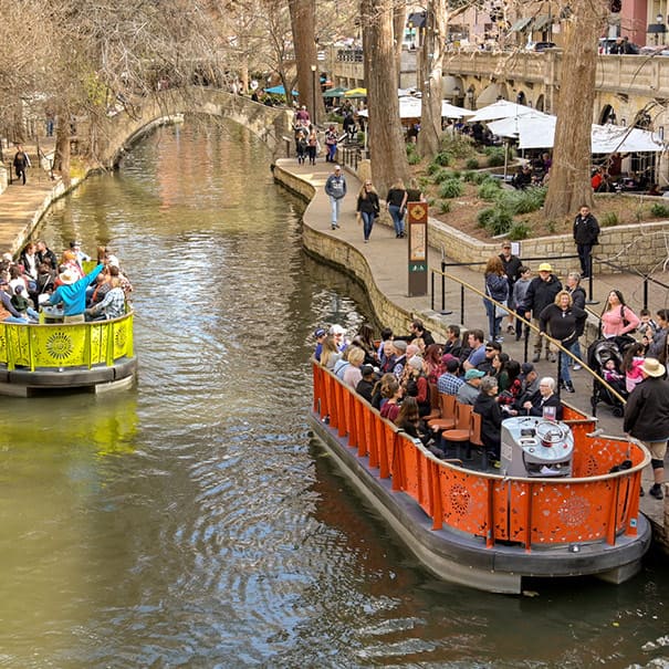 Boats on San Antonio River Walk offering tours in Texas