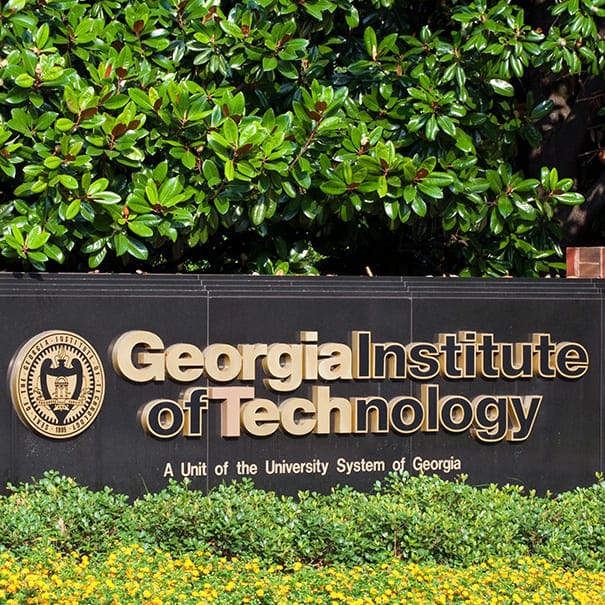 Georgia Institute of Technology campus entrance sign with gold lettering surrounded by greenery.