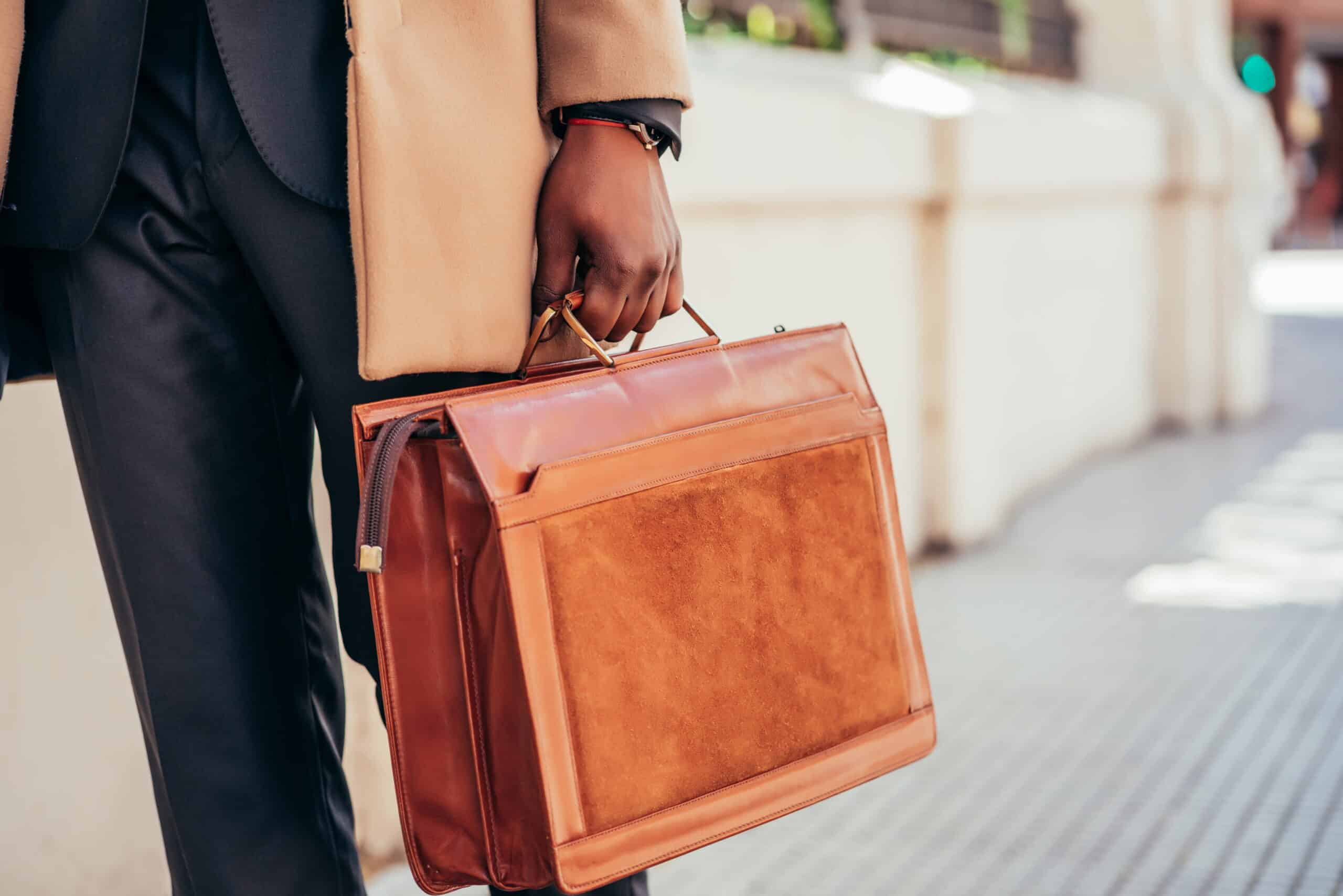 Close-up of a lawyer holding a leather briefcase, symbolizing Posh AI legal support