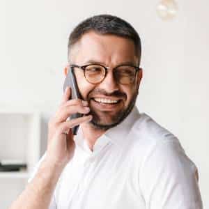 Two professionals smiling on phone calls with Posh AI answering service