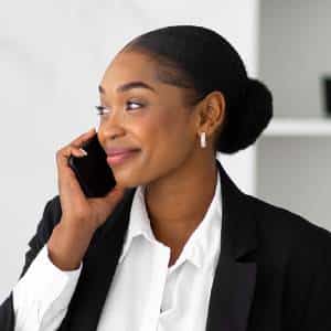 Smiling woman on the phone using Posh AI virtual receptionist services