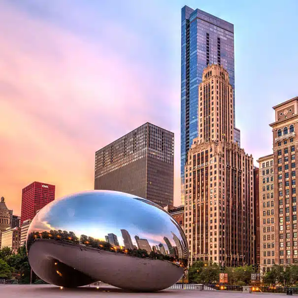 skyline featuring the Cloud Gate sculpture representing businesses served by an Illinois answering service.