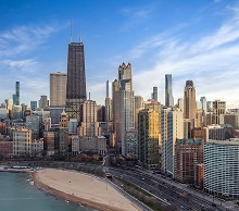 Chicago skyline and sandy lakefront beach on Lake Michigan in golden light